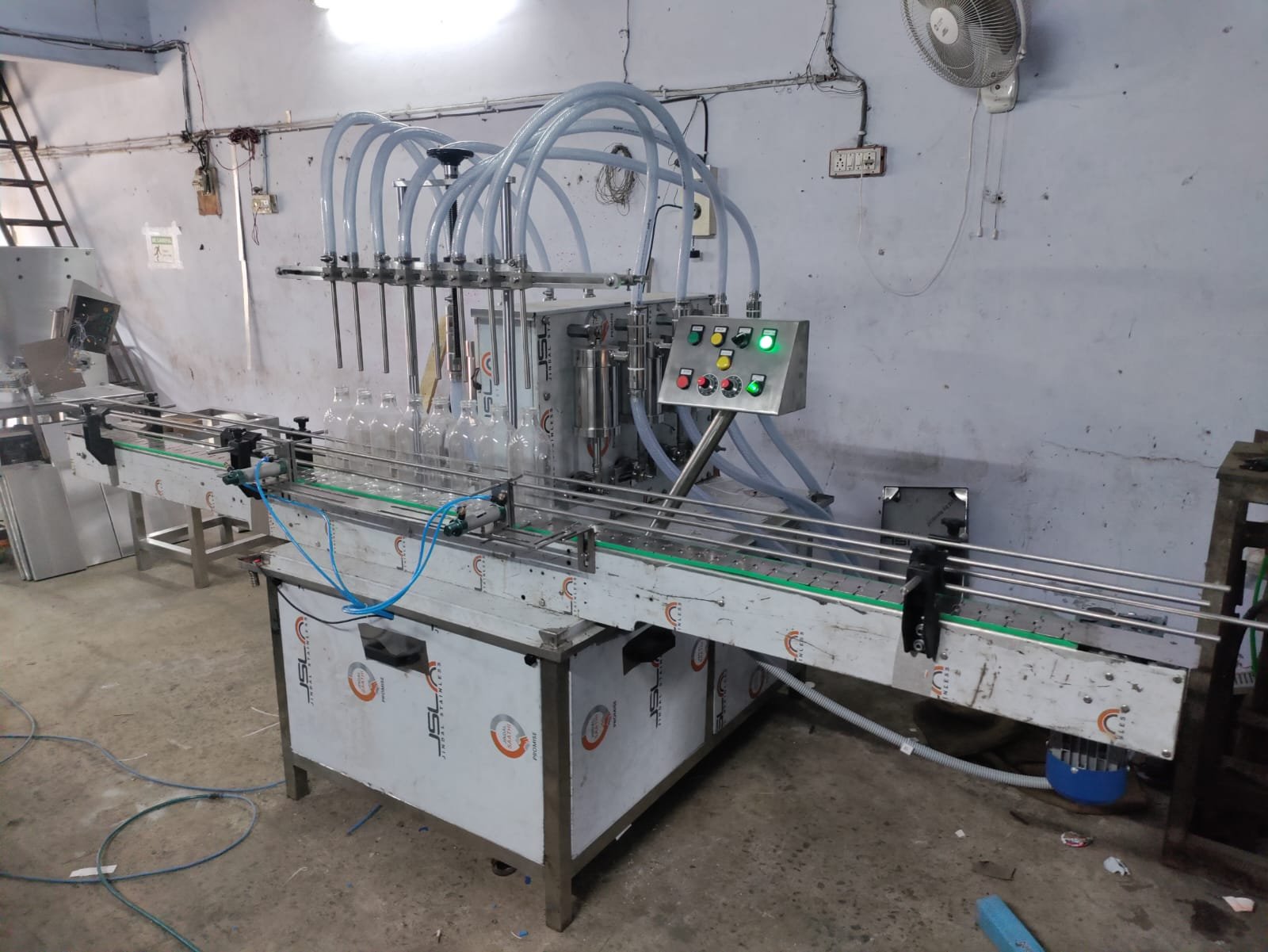 Six-head filling line running on the workshop floor