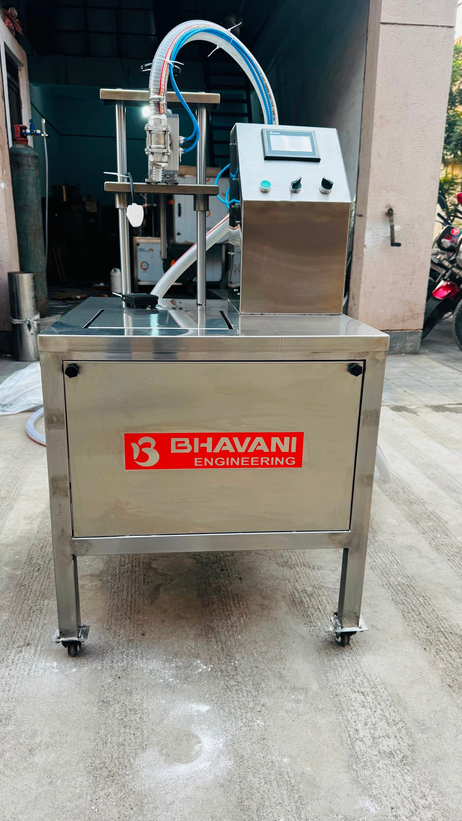 A Bhavani Engineering semi-automatic filling machine on the workshop floor